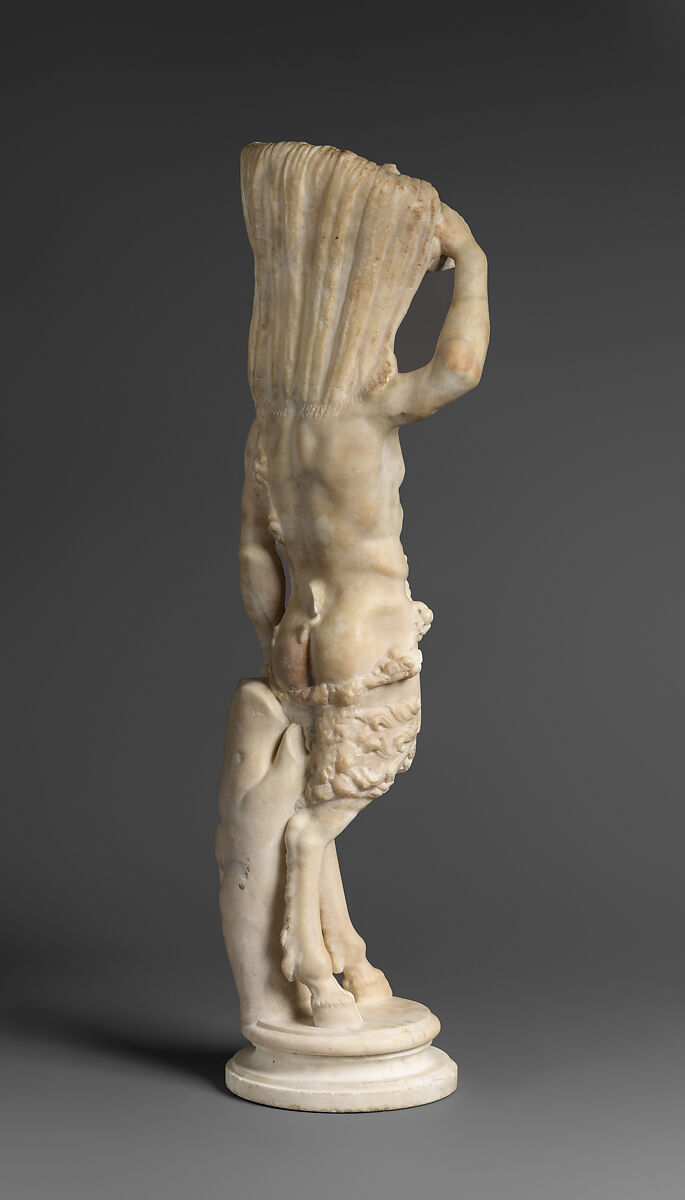 Marble statue of Pan/ Pan or Satyr with winnowing basket filled with offerings and cultic objects, Marble