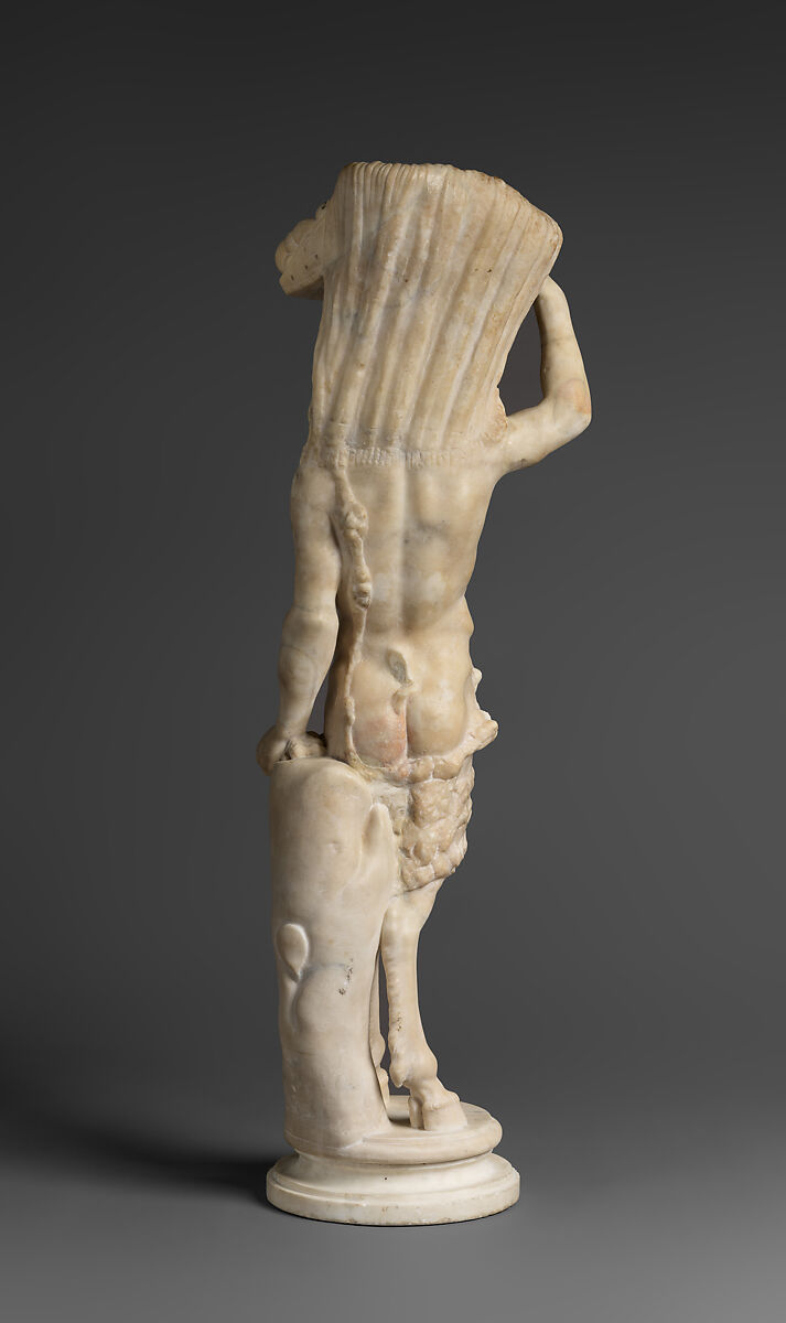 Marble statue of Pan/ Pan or Satyr with winnowing basket filled with offerings and cultic objects, Marble