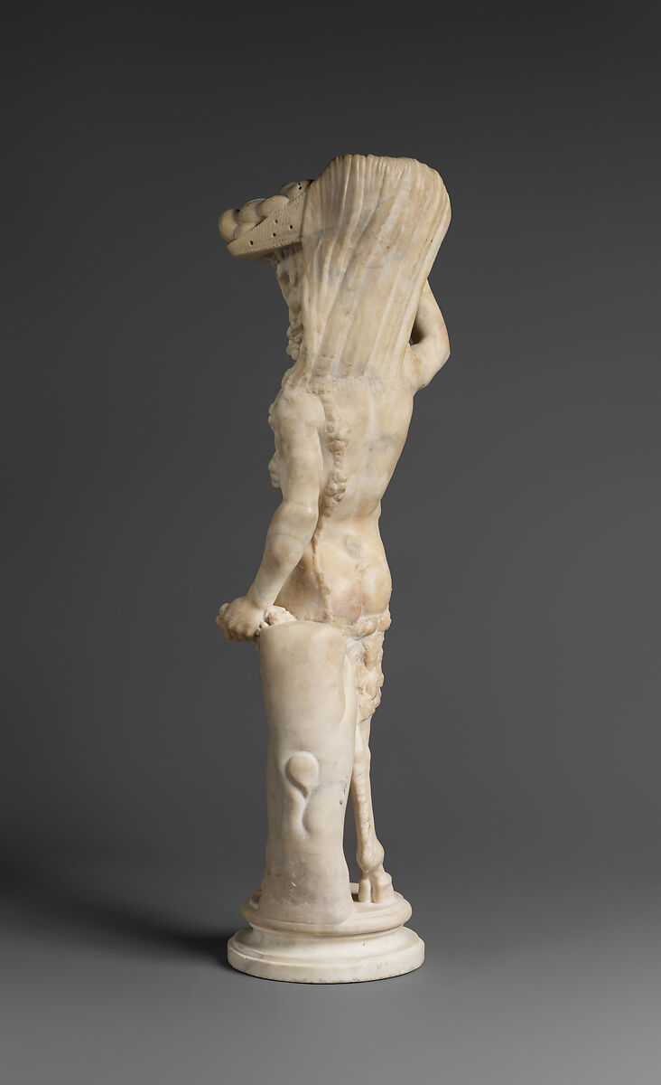 Marble statue of Pan/ Pan or Satyr with winnowing basket filled with offerings and cultic objects, Marble