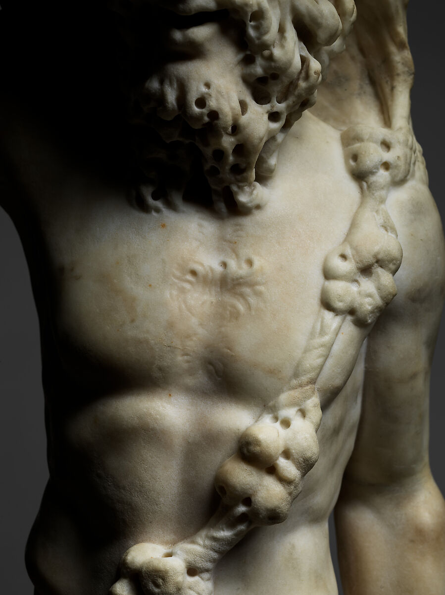 Marble statue of Pan/ Pan or Satyr with winnowing basket filled with offerings and cultic objects, Marble