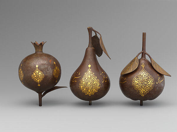 Three Qajar Gold-Damascened Steel Fruits, Steel; damascened with gold