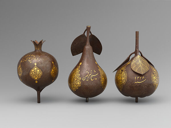 Three Qajar Gold-Damascened Steel Fruits, Steel; damascened with gold