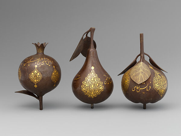 Three Qajar Gold-Damascened Steel Fruits, Steel; damascened with gold