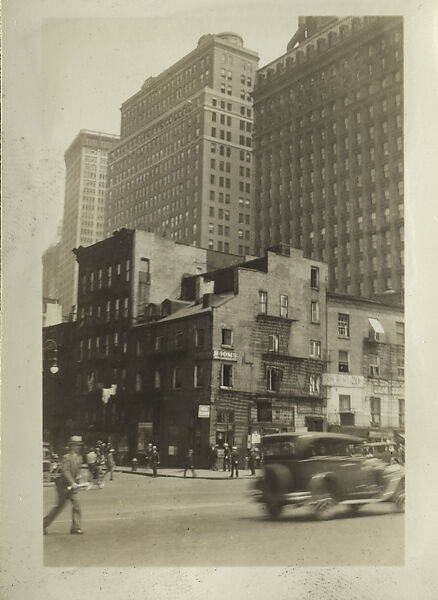 [New York Album: Street Corner with Moving Car and Pedestrian in Foreground], Berenice Abbott (American, Springfield, Ohio 1898–1991 Monson, Maine), Gelatin silver print 